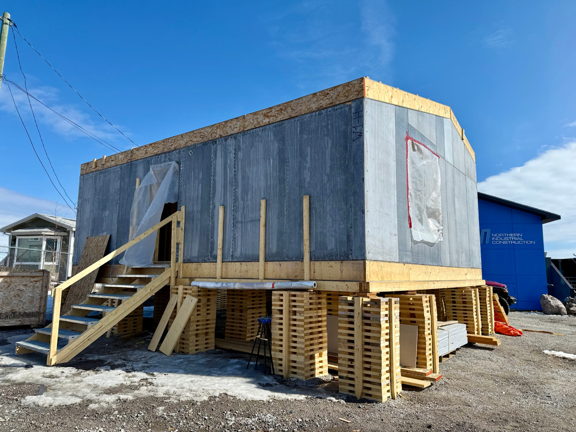 A Kuponya modular home under construction on a raised foundation
