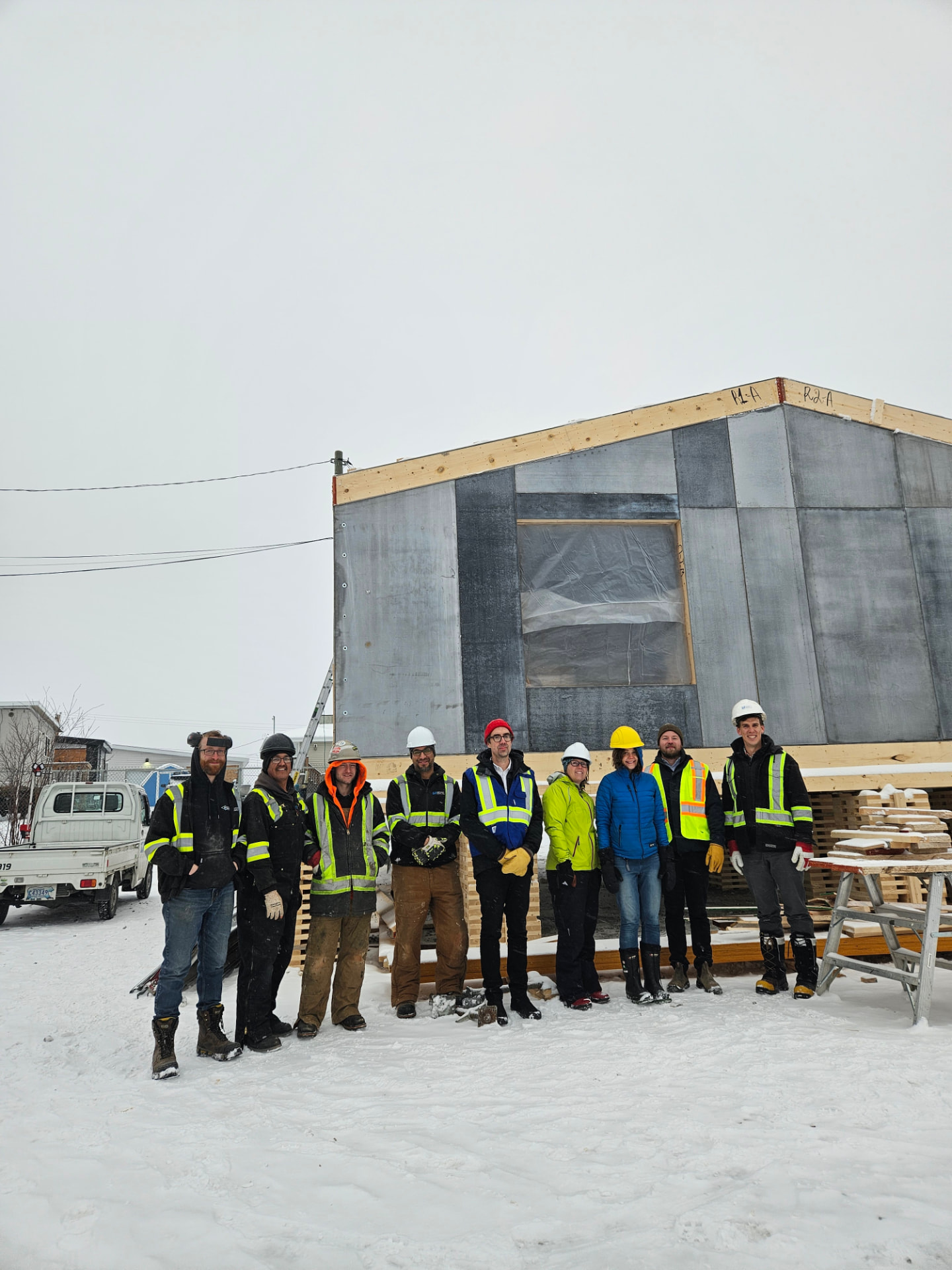 A build crew standing in front of a Kuponya home under construction